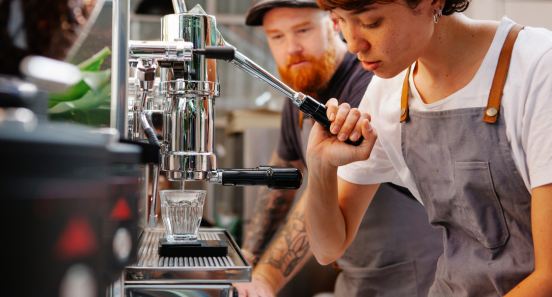 employees making coffee in a coffee shop