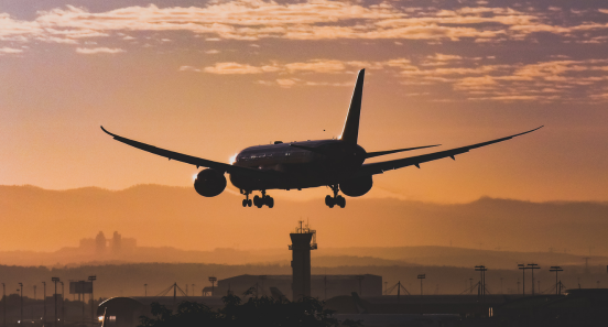 plane taking off into the sunset