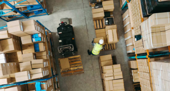 birds eye view of a worker sorting packages in a warehouse 